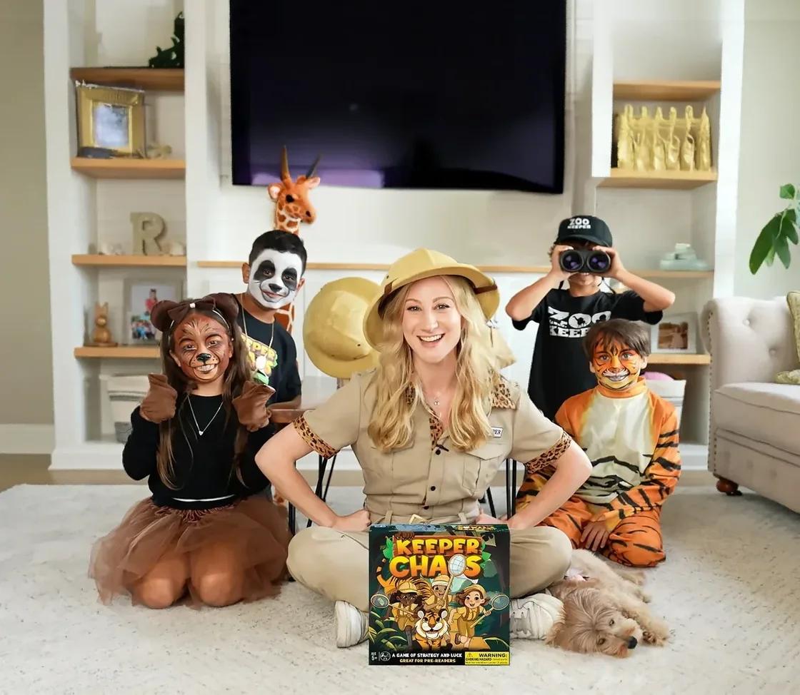 The Hour Time Games family in zookeeper costumes and animal face paint, gathered around the Keeper Chaos box